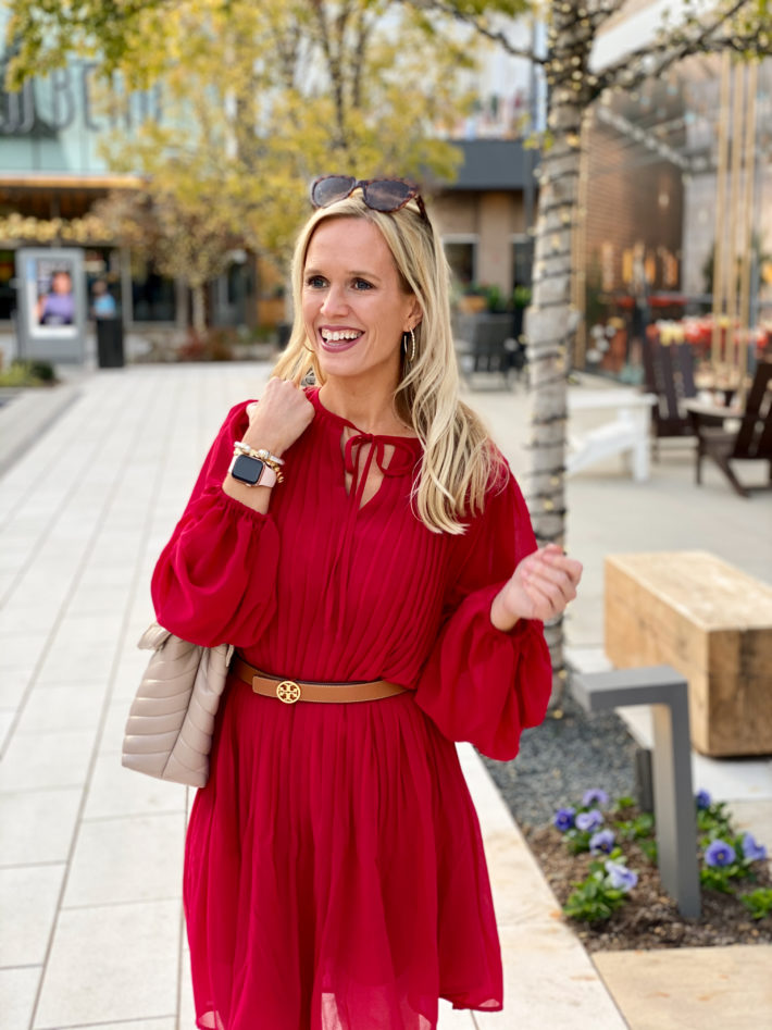 This pleated red dress is so perfect for the holidays. Wear it as a shift dress or add a belt to it for a slimming holiday outfit! 