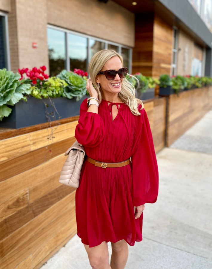 This pleated red dress is so perfect for the holidays. Wear it as a shift dress or add a belt to it for a slimming holiday outfit! 