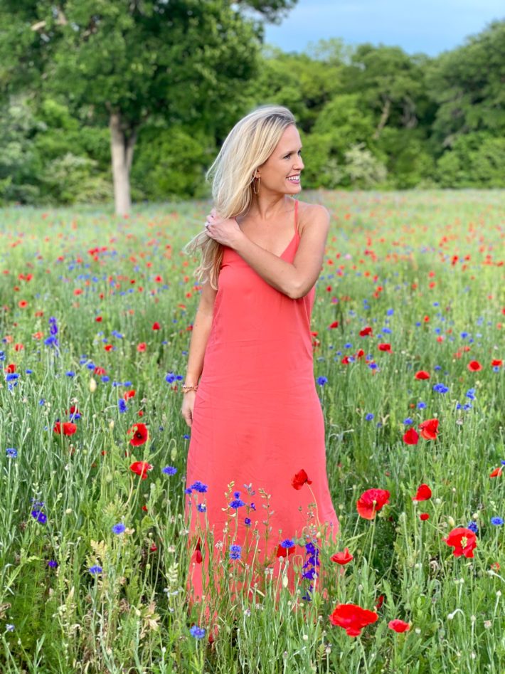Surrounded by Texas wildflowers doing an Old Navy spring haul featuring affordable fashion. 