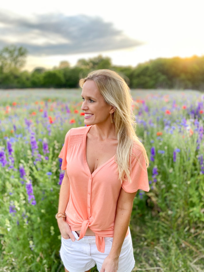 Surrounded by Texas wildflowers doing an Old Navy spring haul featuring affordable fashion. 
